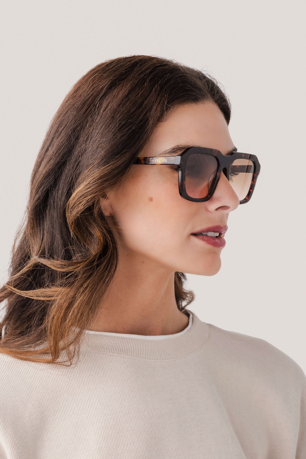 Rectangular acetate sunglasses with dark tortoise frame and dark lenses, profile view