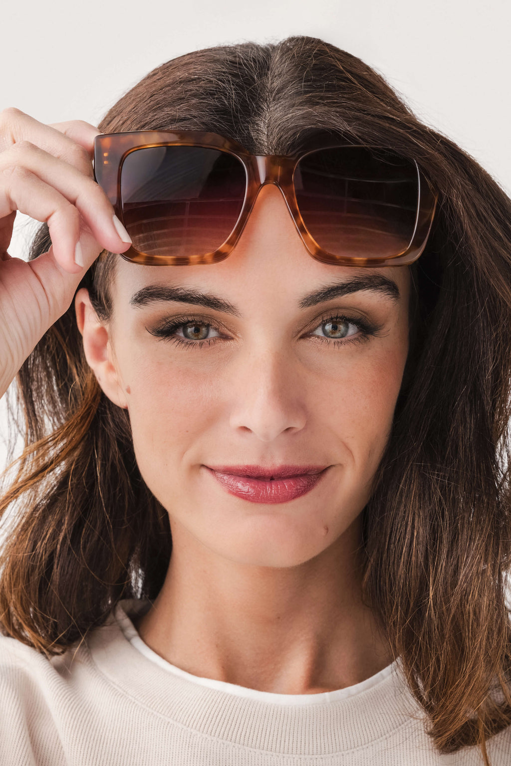 Oversized brown acetate sunglasses with dark tinted lenses, square frame front view