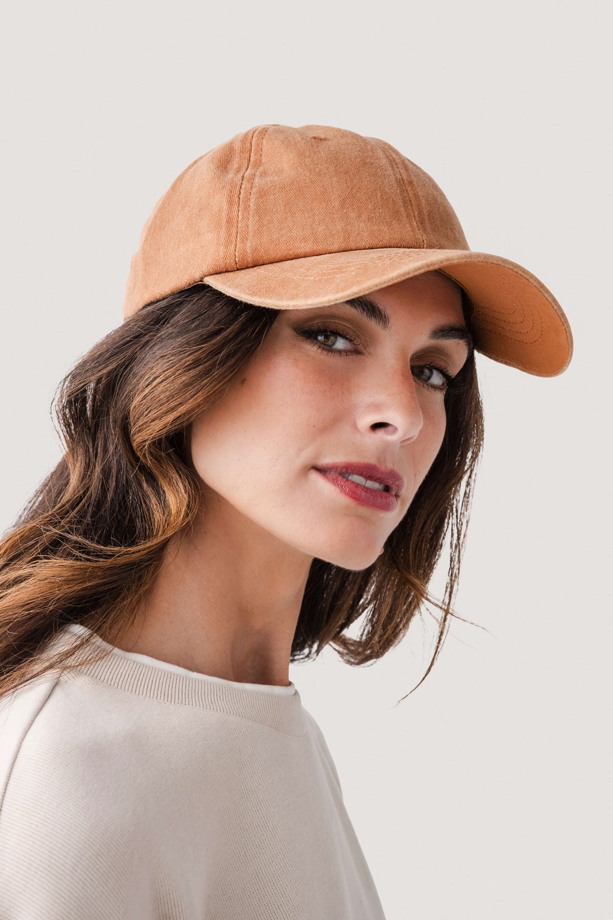 Amber orange classic baseball cap, angled front view with curved brim