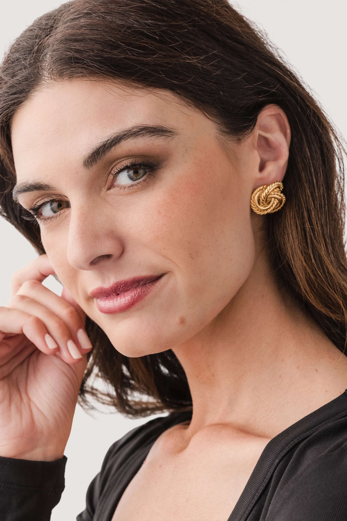 Susan Shaw gold knot earrings on model, stud with braided knot