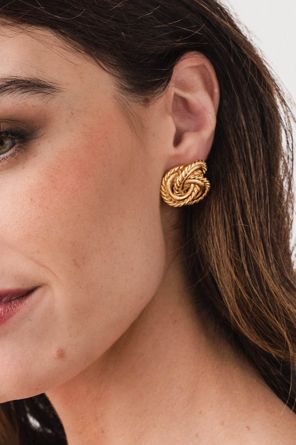 Susan Shaw gold knot stud earrings, textured rope knot on ear