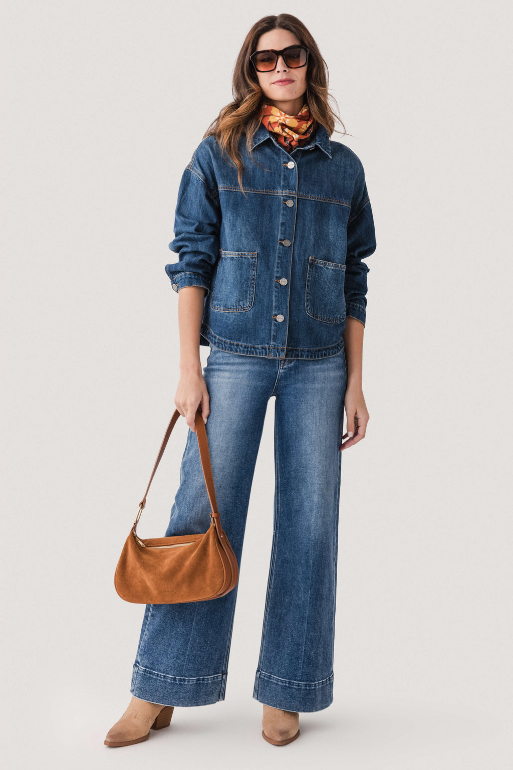 Blue wide-leg denim jeans with button fly, front pockets, and cuffed wide hem