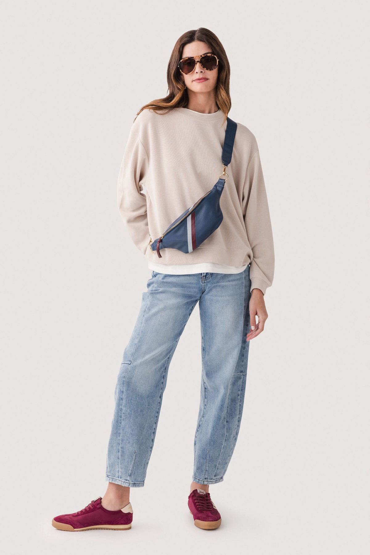 Light beige crewneck pullover sweater with long sleeves and ribbed cuffs