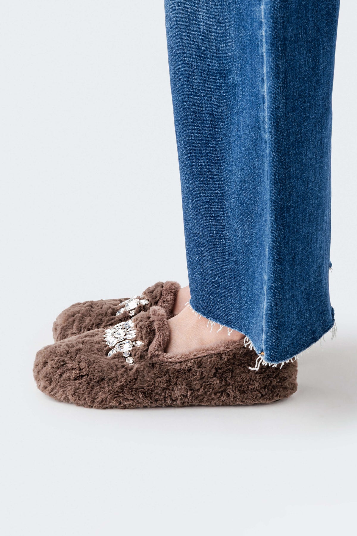 Brown fuzzy slip-on loafer slipper with silver gem flower detail on the front.