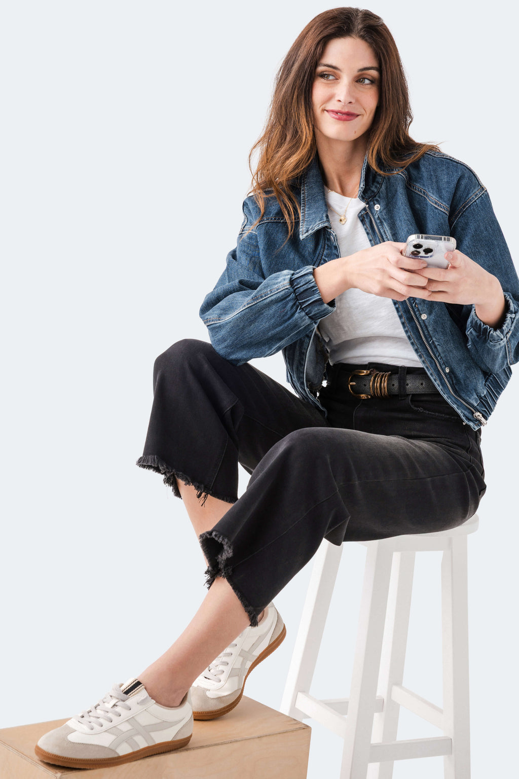 Black cropped straight-leg jeans with frayed hem, button fly, and belt loops.