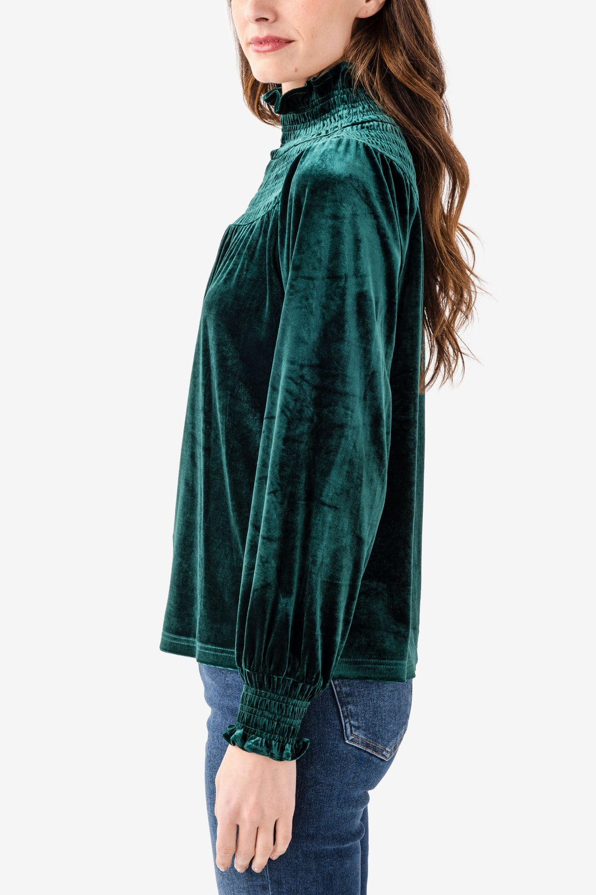 Emerald velvet smocked high-neck top with long sleeves, side view