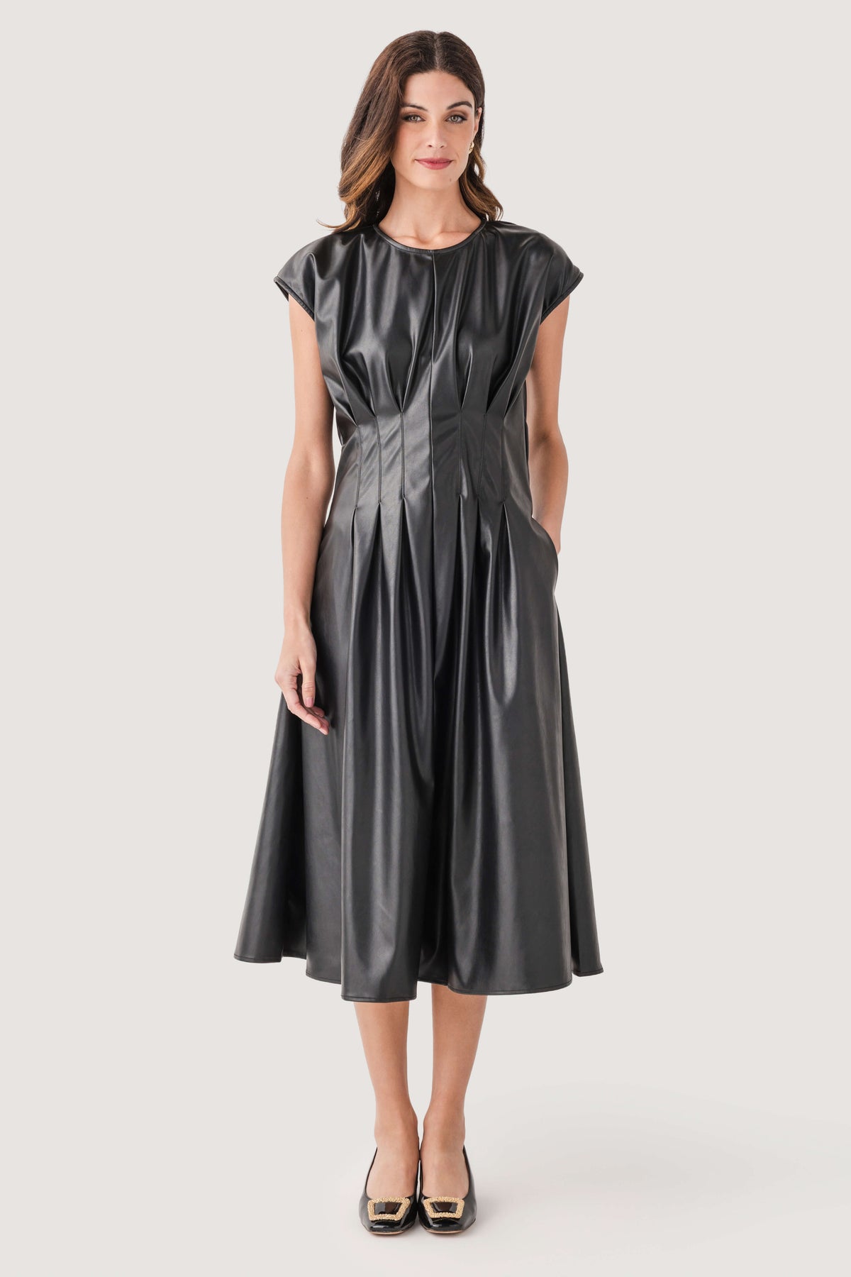 Black faux-leather pleated midi dress with cap sleeves and round neckline.