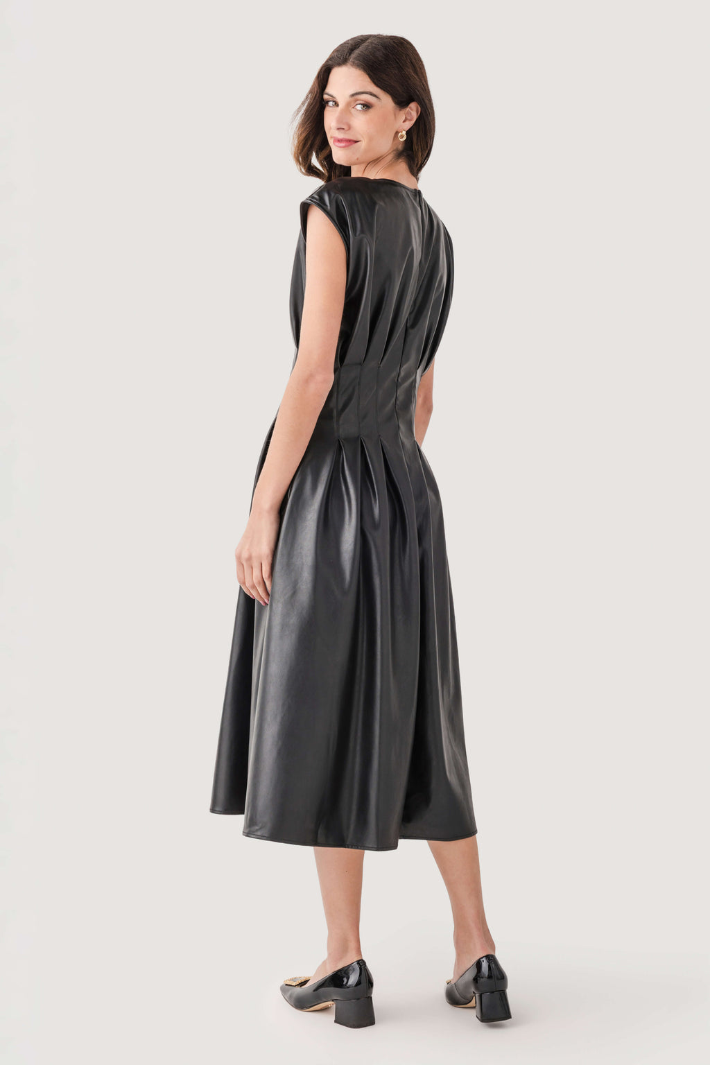 Black faux-leather pleated midi dress, fitted waist, sleeveless, midi length.