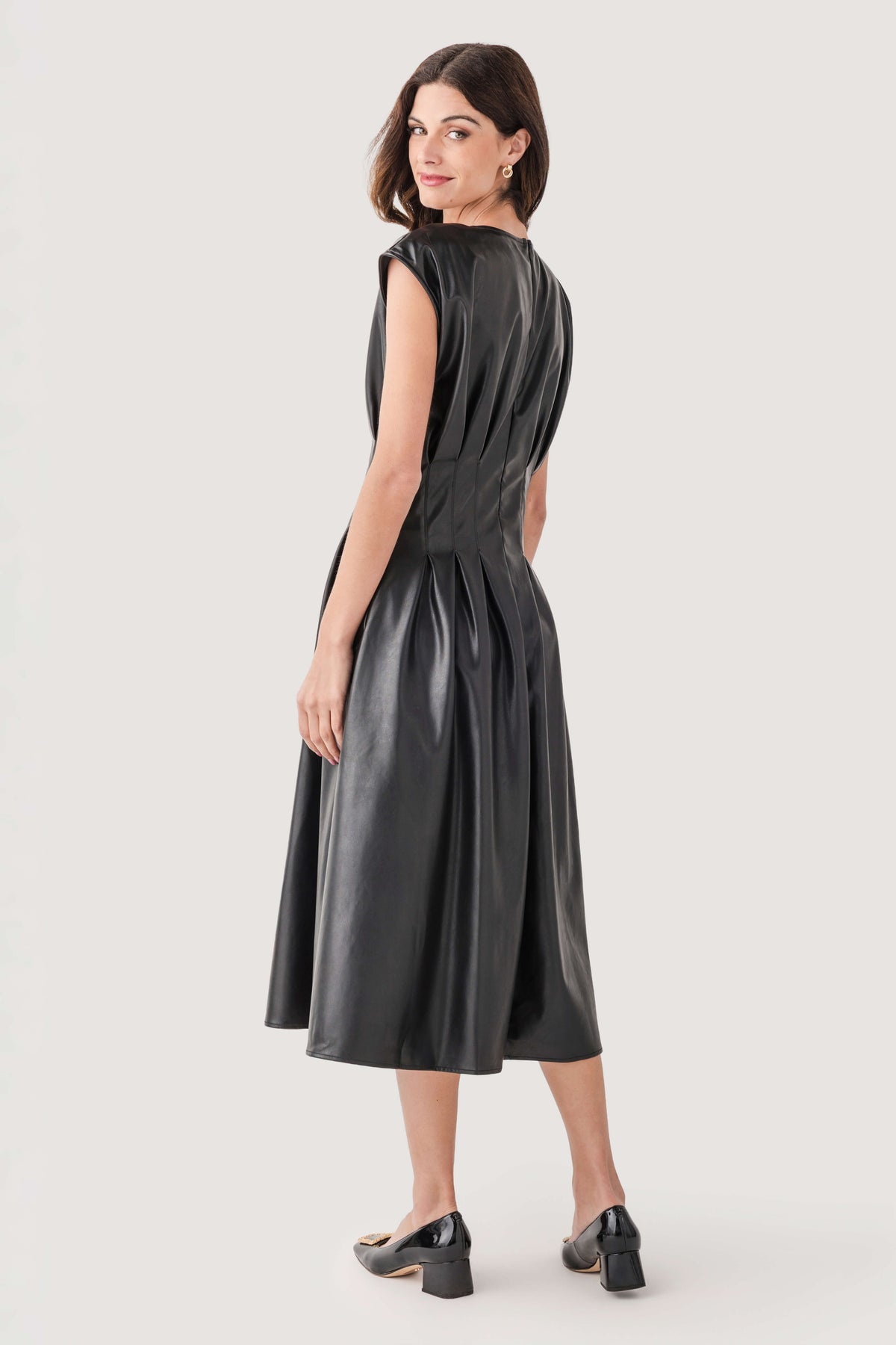 Black faux-leather pleated midi dress, fitted waist, sleeveless, midi length.