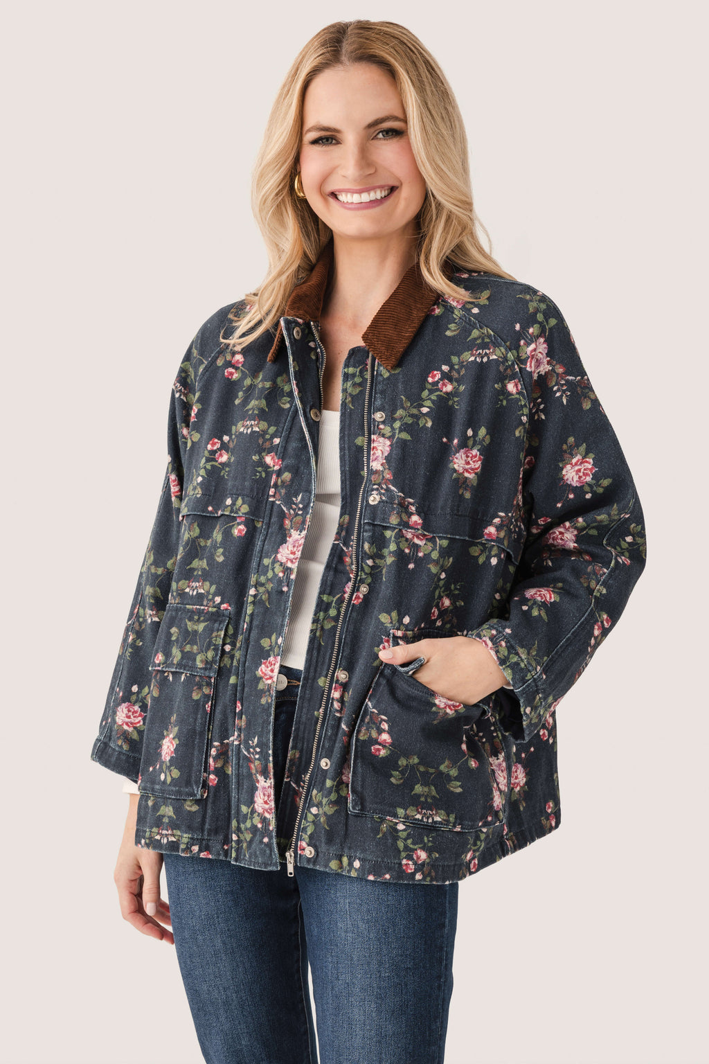Floral printed utility jacket featuring a full zipper, side pockets, and rounded collar, dark navy.