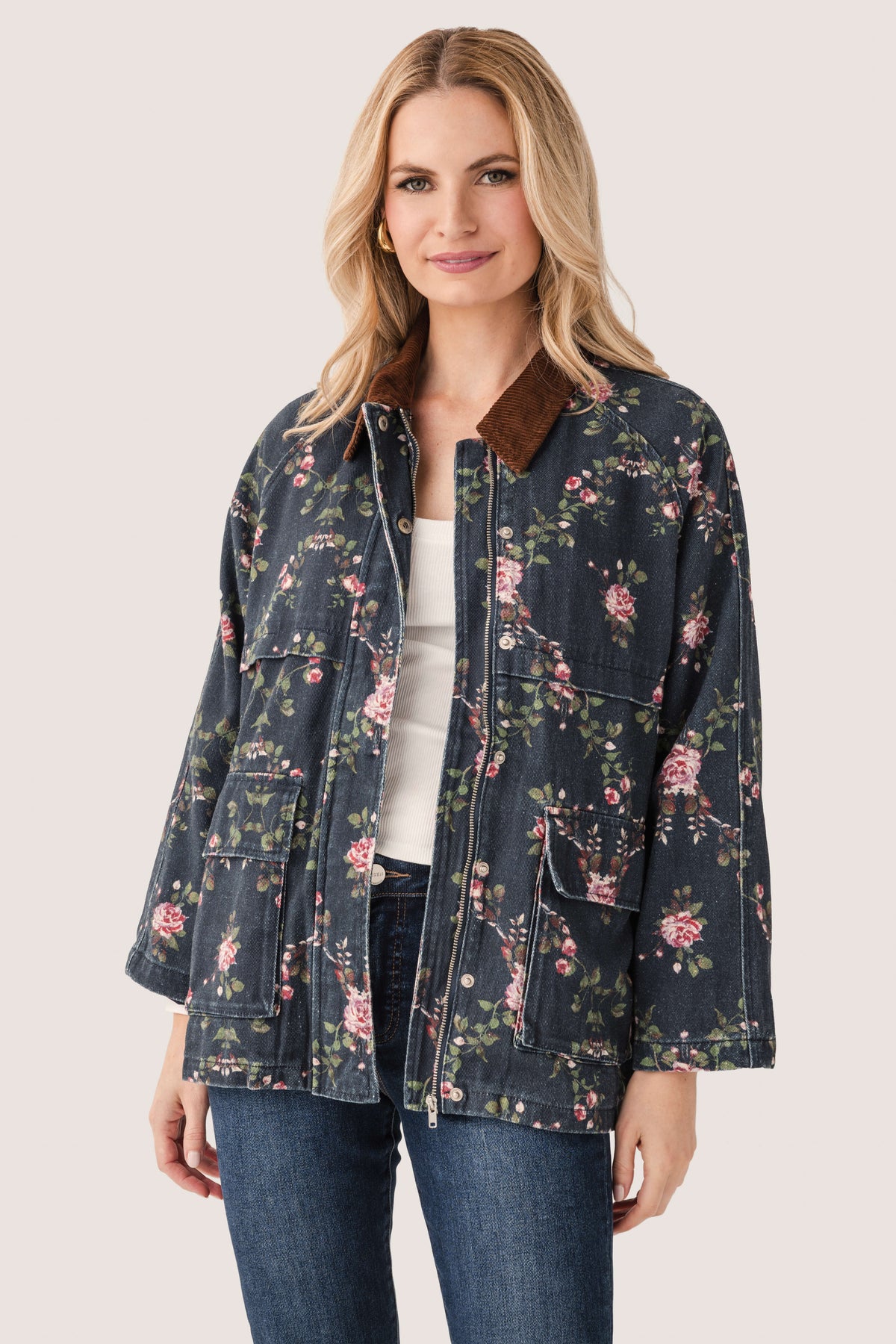 Floral utility jacket with full zipper and flap pockets, dark navy with pink and green flowers.