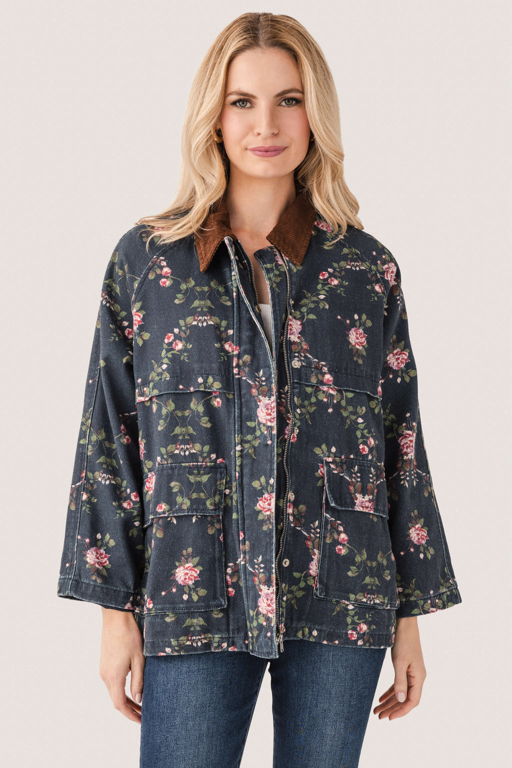 Floral printed utility jacket with zip front and flap pockets, dark navy floral pattern detail.