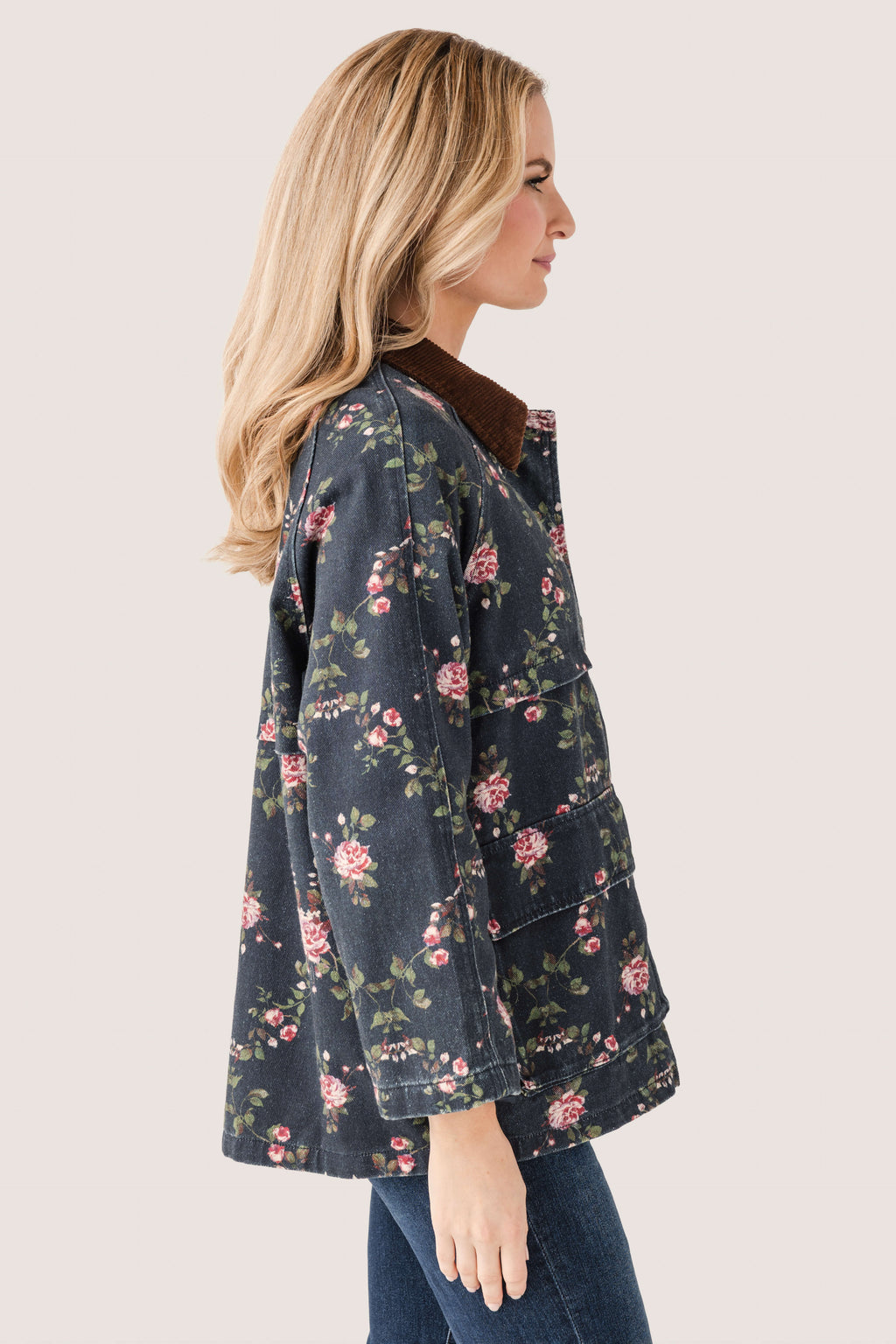 Floral utility jacket shown from the side, full zipper and pockets, dark navy floral print.