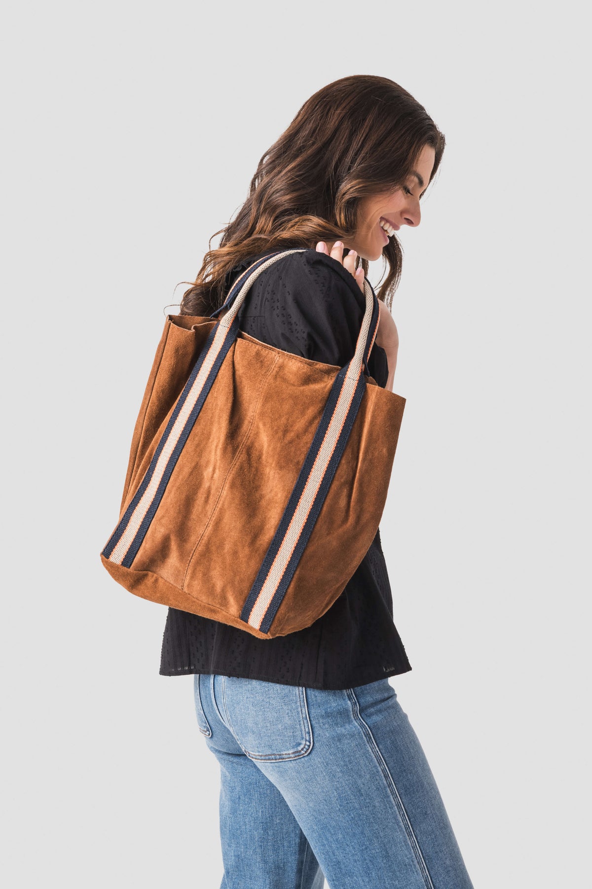 Tan suede leather tote bag, striped trim on sides, two top handles