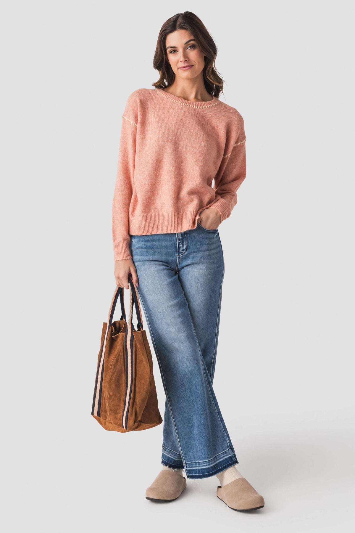 Dusty coral crewneck sweater with contrast stitch neckline and ribbed cuffs