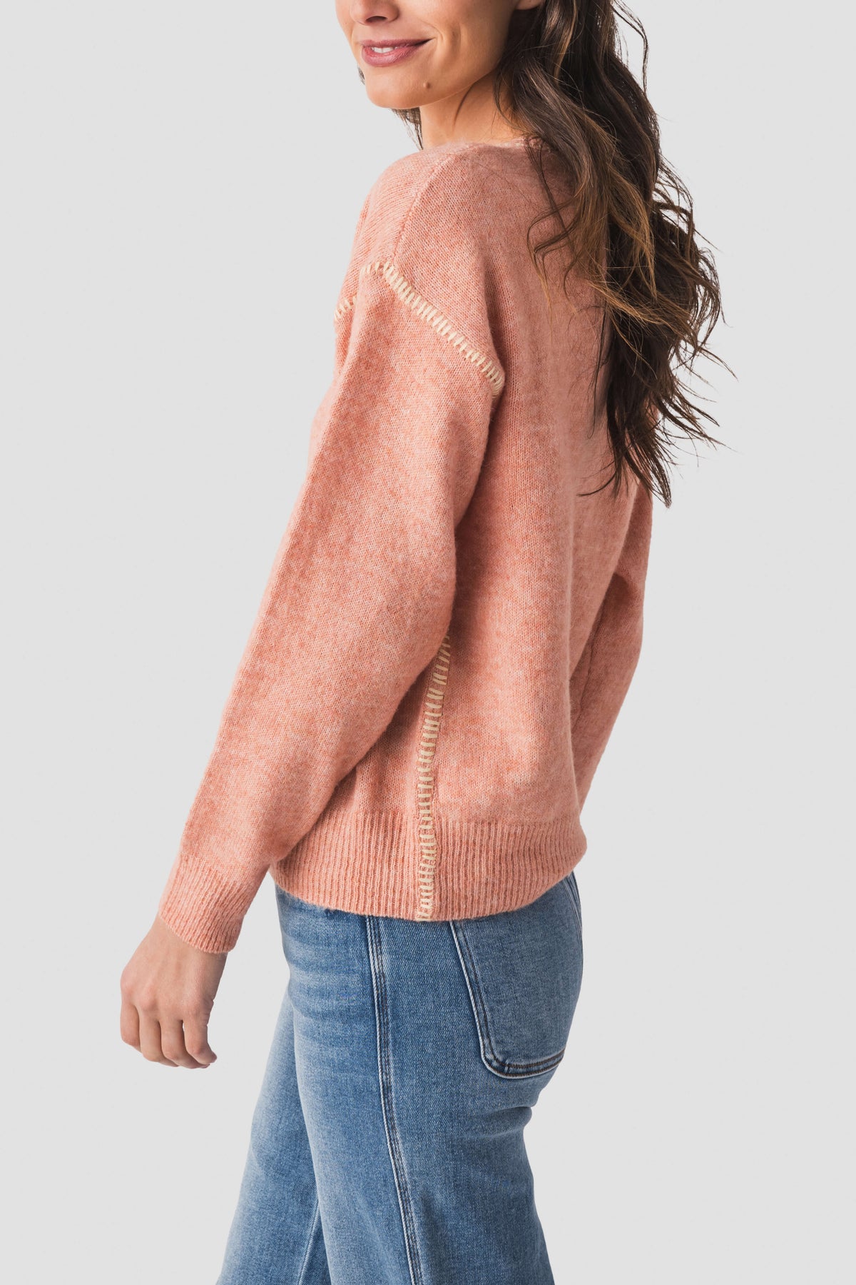 Dusty coral knit sweater with contrast stitch on shoulder seam and ribbed hem