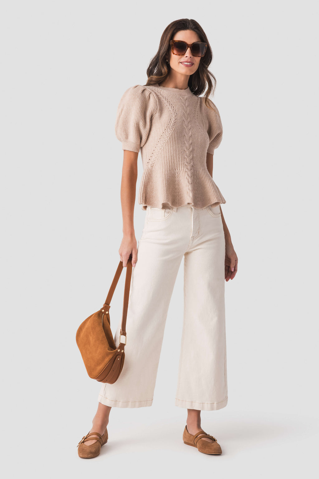 Oatmeal knit peplum top with puff sleeves and cable-texture knit front detail.