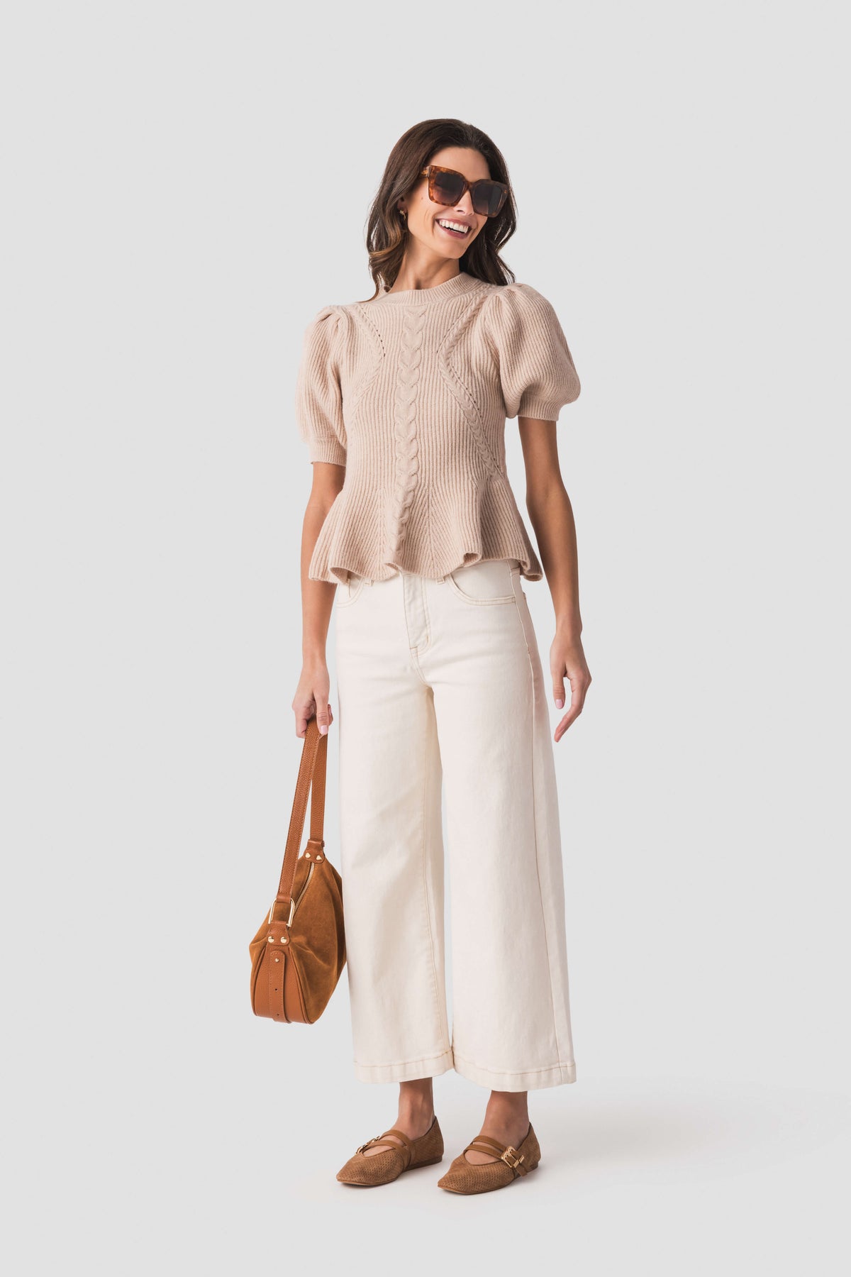 Oatmeal textured knit peplum top with short puff sleeves and rounded neckline.