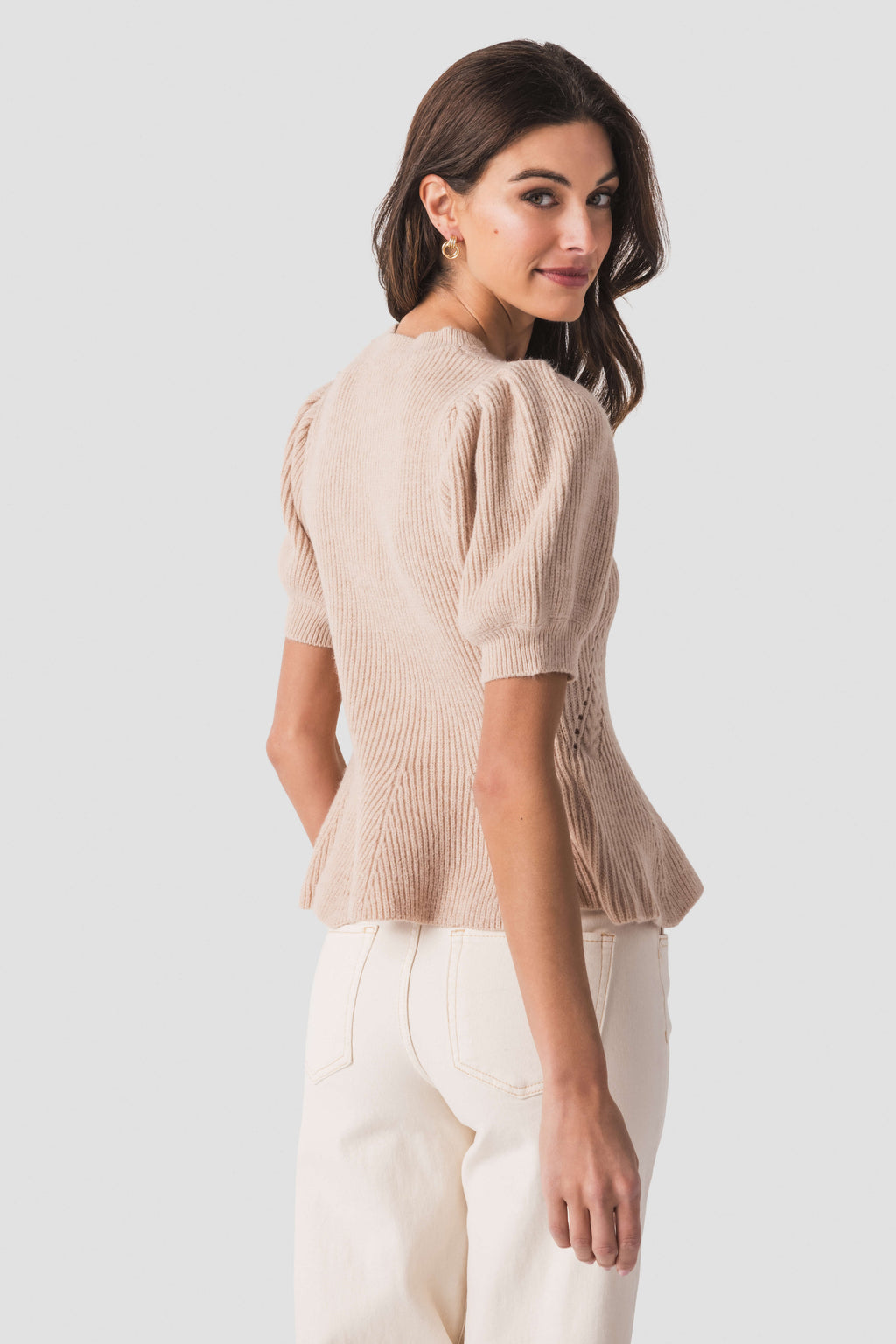 Oatmeal knit peplum top, side/back view with puff sleeves and vertical ribbed texture.