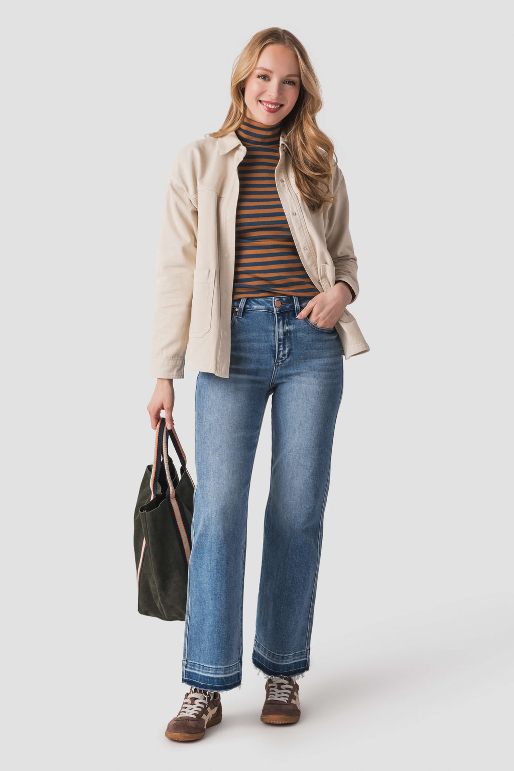 Women’s parchment jacket worn over striped top with button front and long sleeves