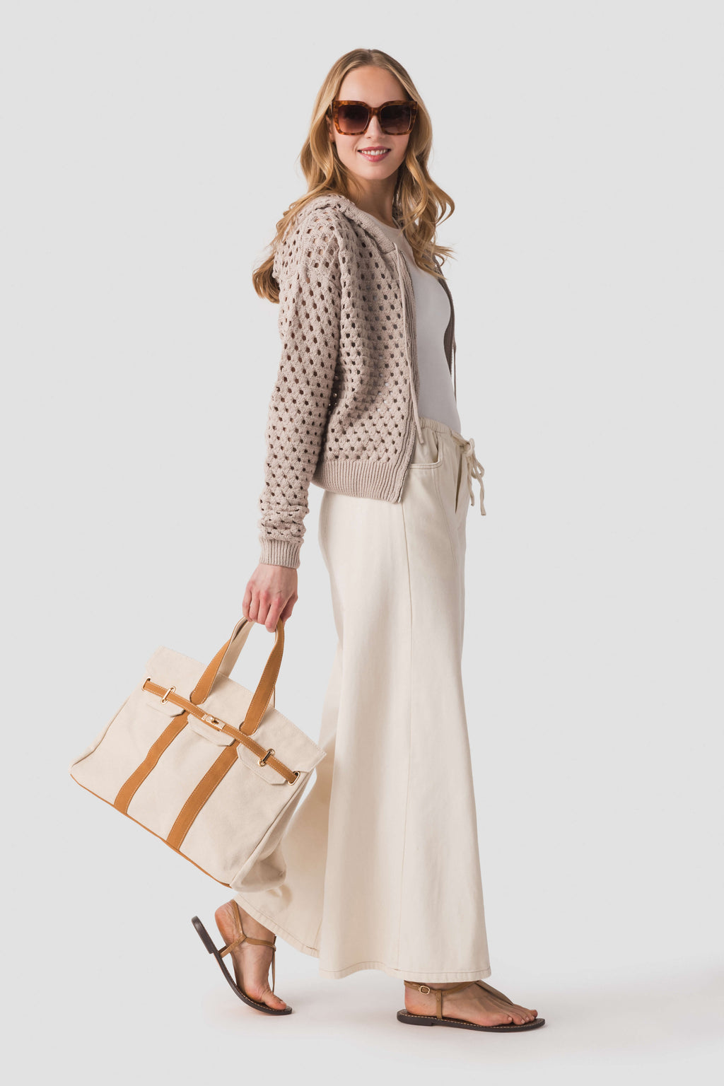 Tan canvas tote bag with tan leather-look straps and handles
