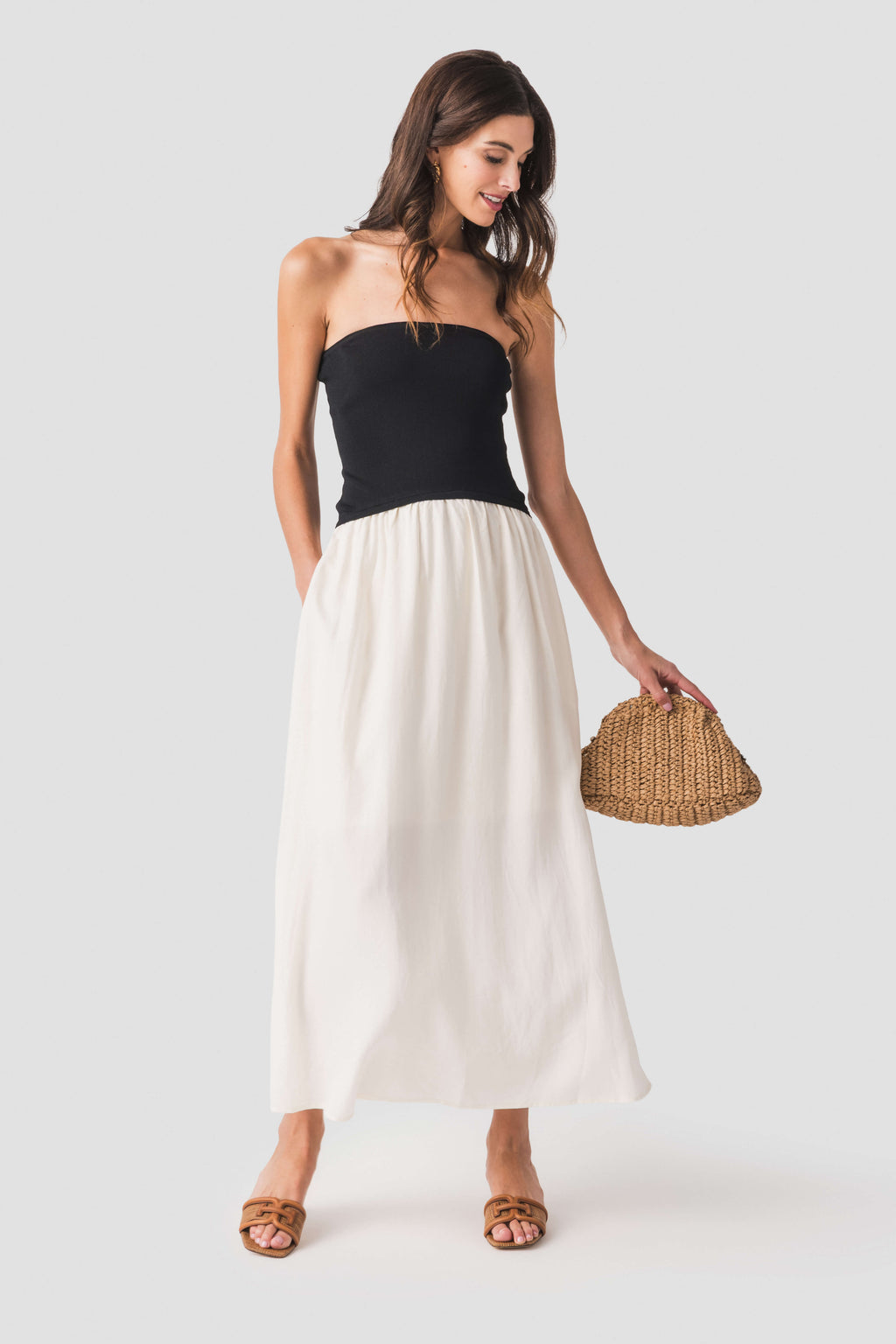 Strapless two-tone midi dress with black bodice and flowy cream skirt