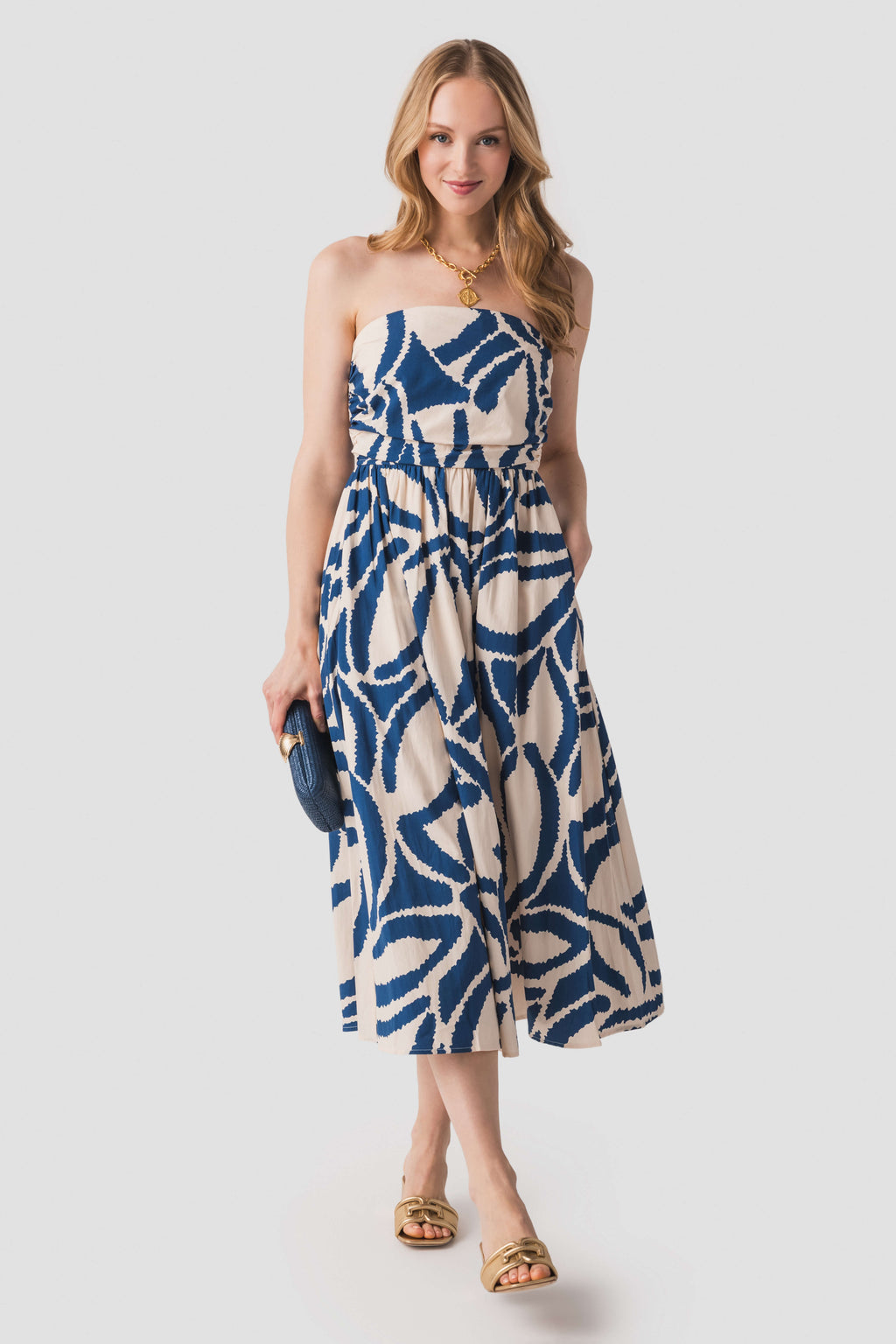Tube top midi dress with blue-and-white abstract pattern, gathered waist and flared skirt