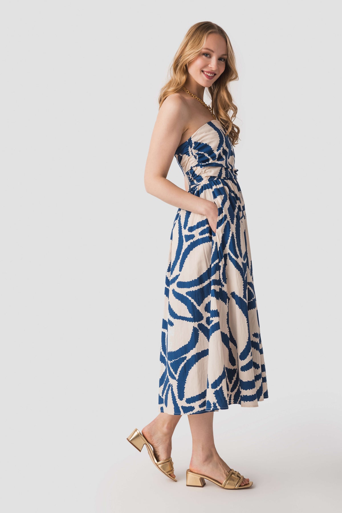 Blue-and-white strapless midi dress with abstract print, fitted bodice and flared hem