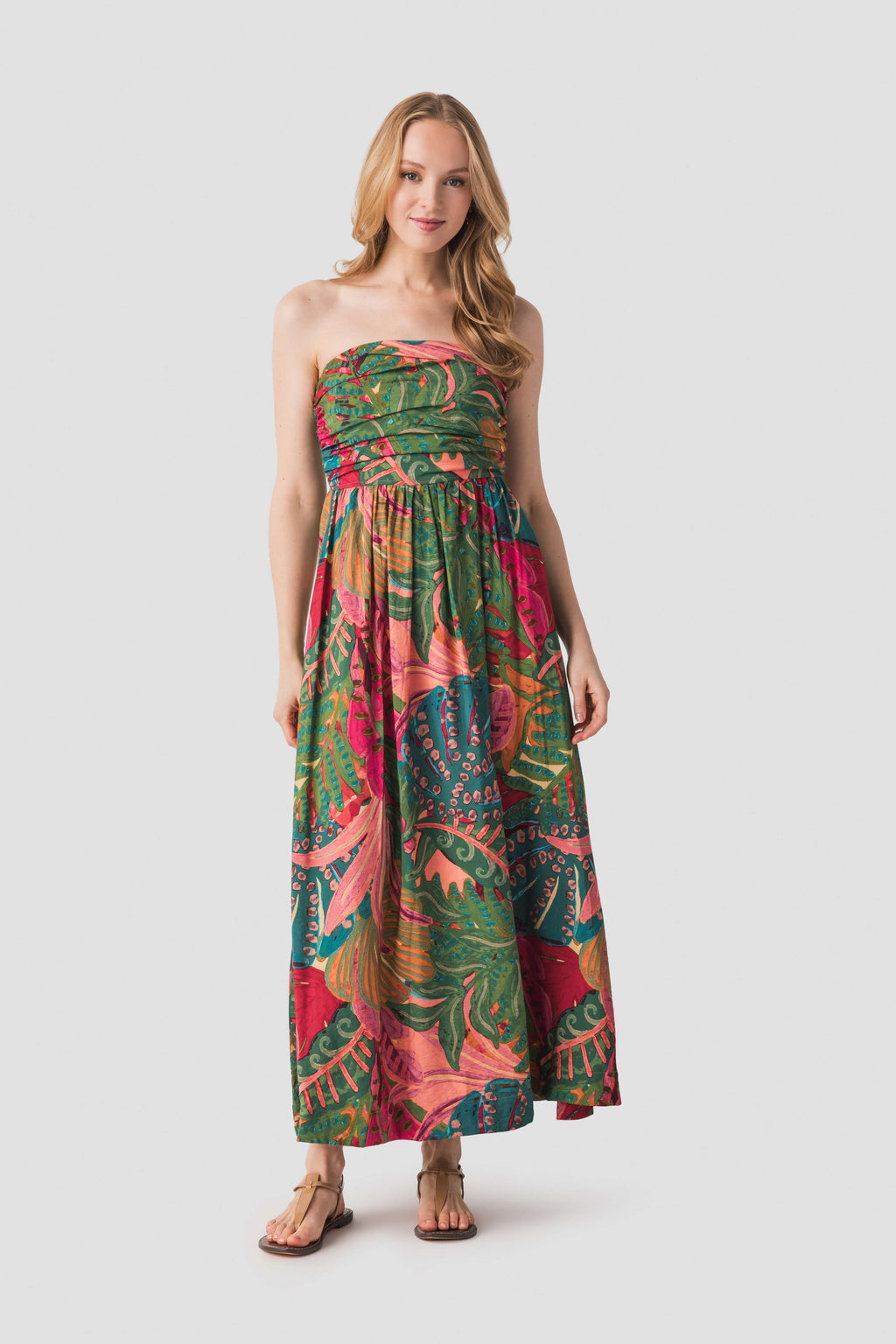 Strapless ruched maxi dress in tropical leaf-and-floral print, coral pink, teal, and green.