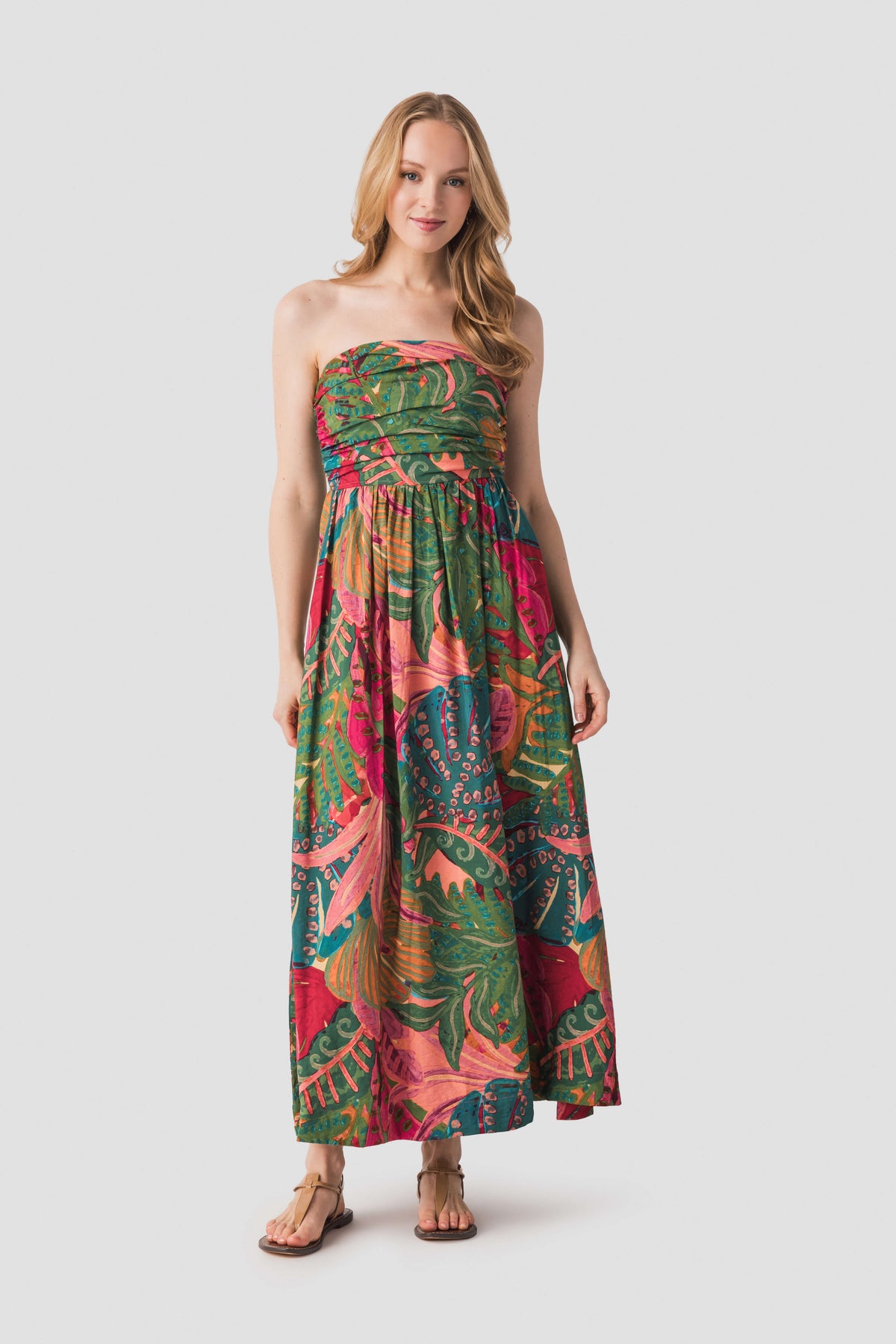 Strapless ruched maxi dress in tropical leaf-and-floral print, coral pink, teal, and green.