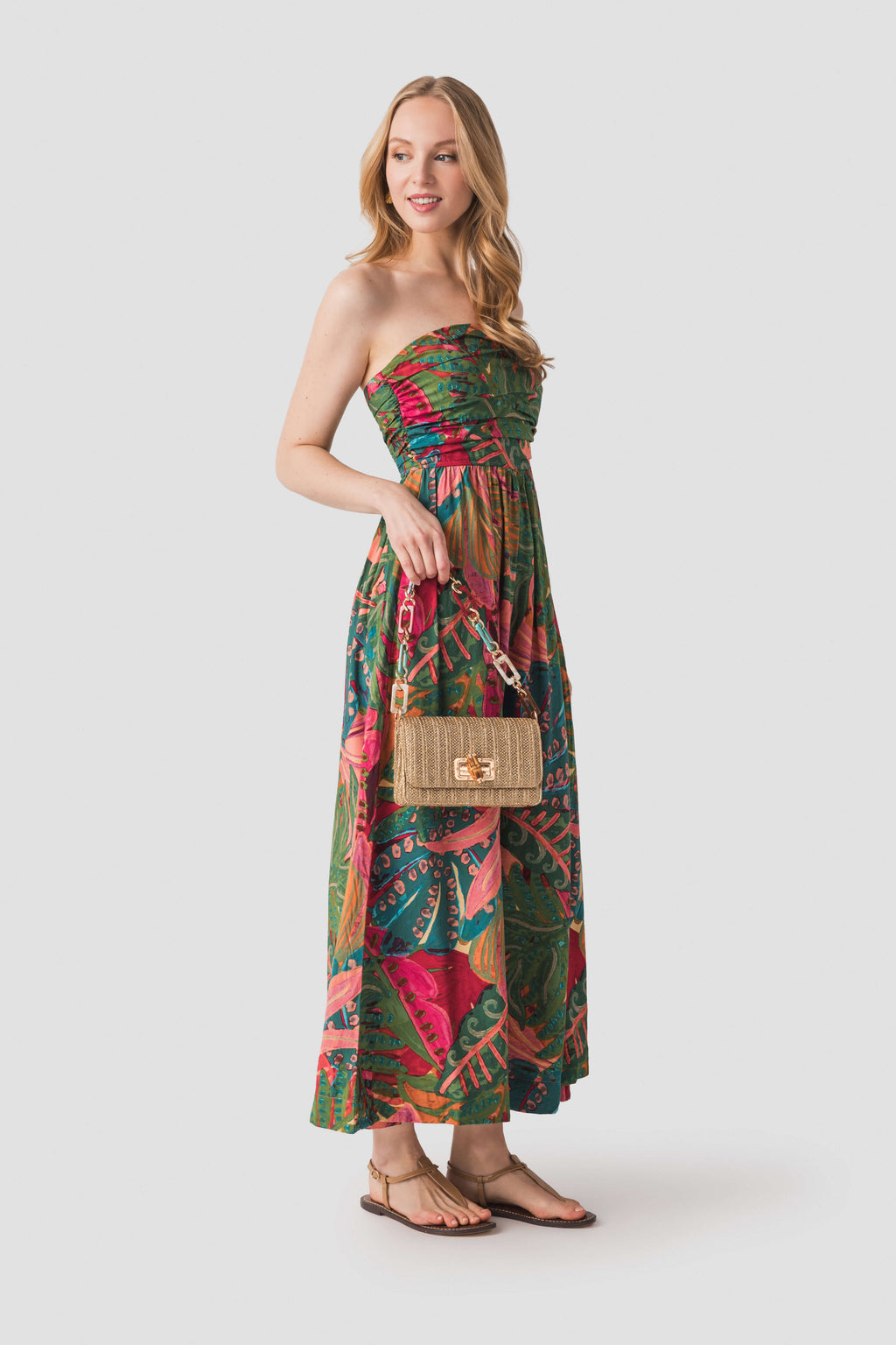 Strapless ruched maxi dress with tropical leaf and floral print, coral-pink and green.
