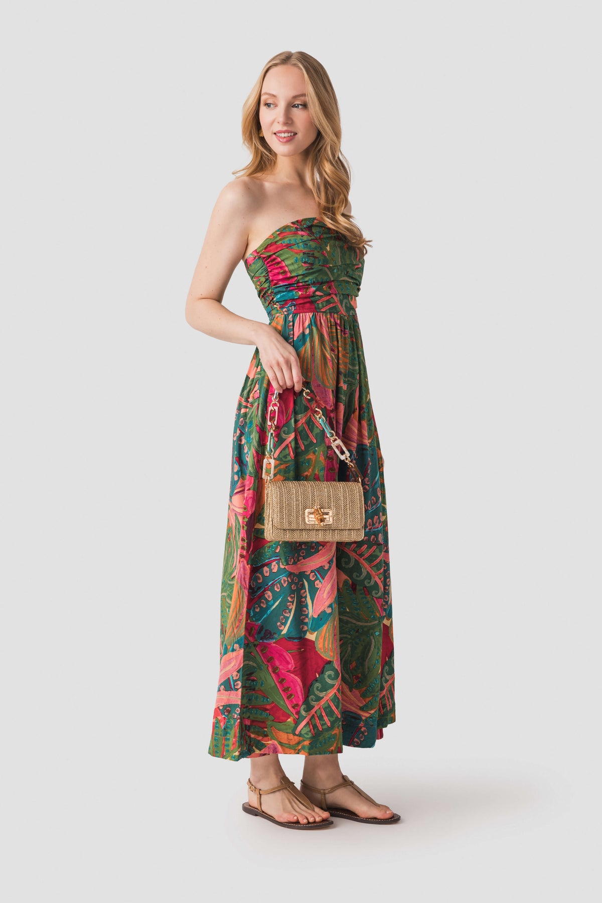 Strapless ruched maxi dress with tropical leaf and floral print, coral-pink and green.