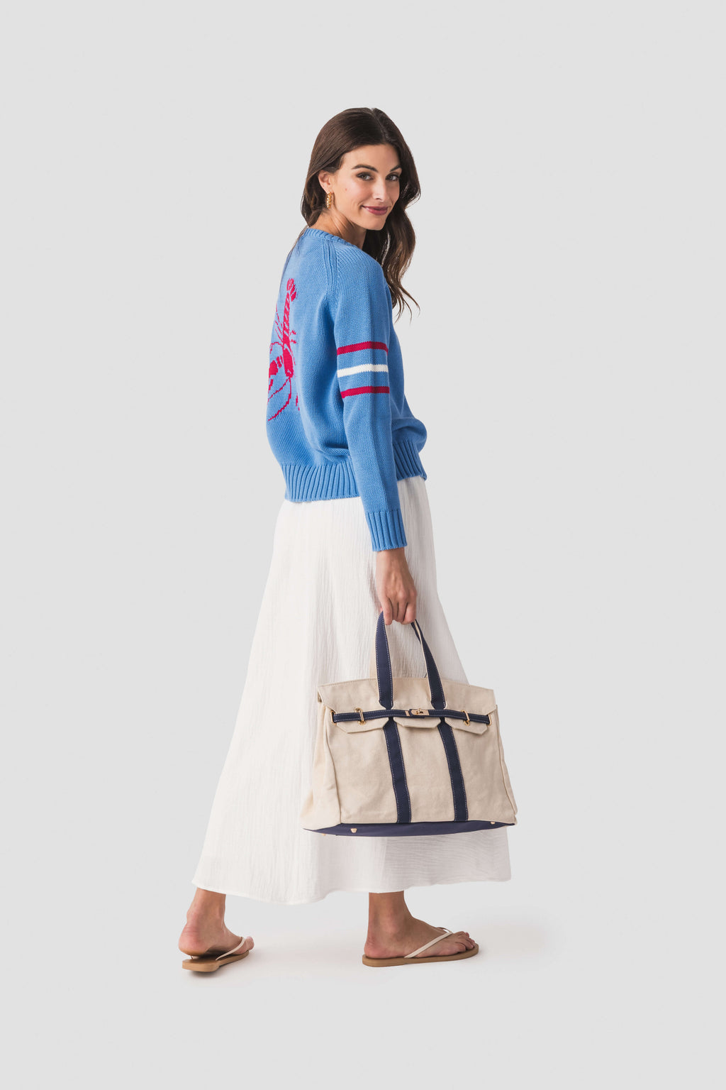 Cream canvas tote bag with navy striped panels and top handles