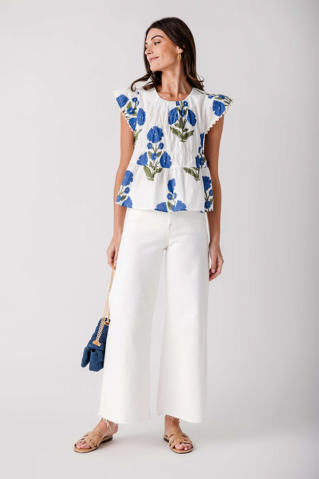 Cream wide-leg palazzo pants with raw hem and clean, minimal front detailing