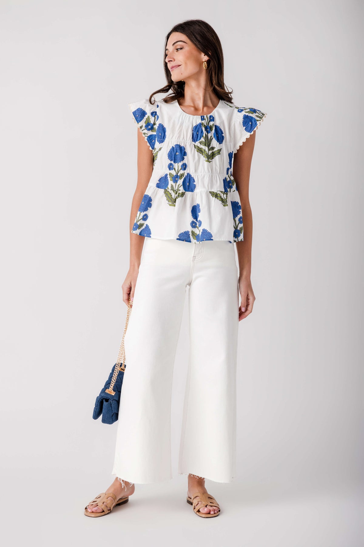 Cream wide-leg palazzo pants with raw hem and clean, minimal front detailing