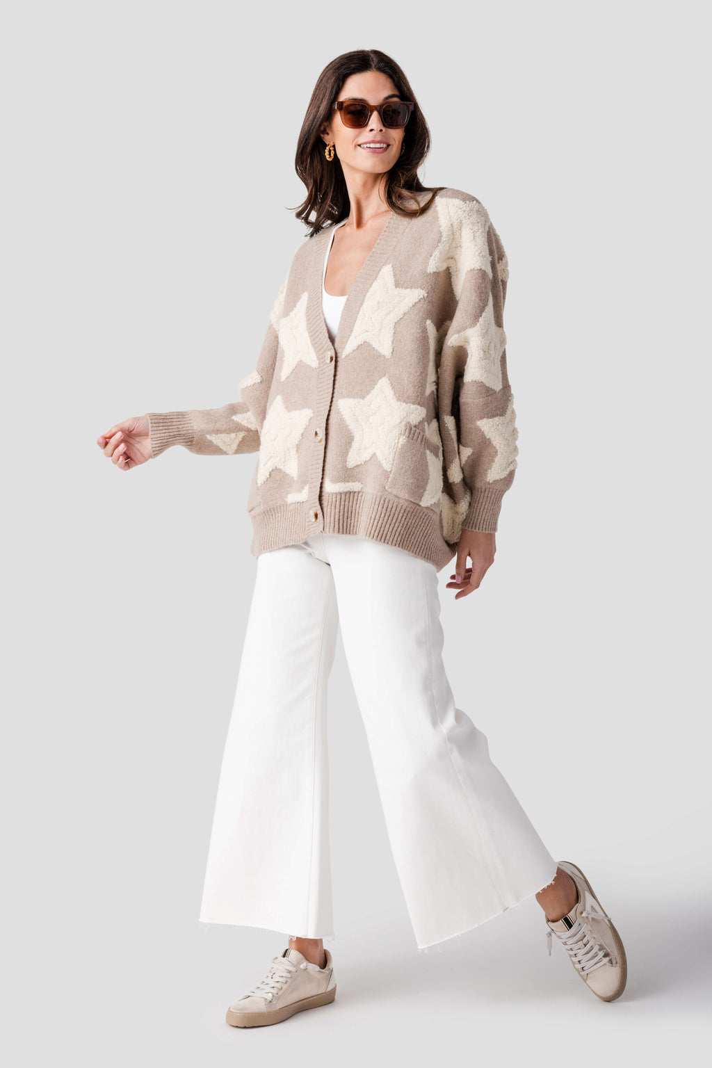 Cream palazzo pants with raw hem, wide flare legs, and front pockets