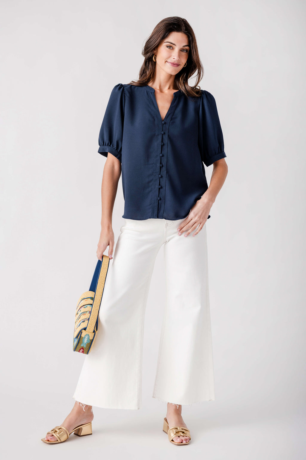 Cream palazzo pants with raw hem, front button closure, and wide legs