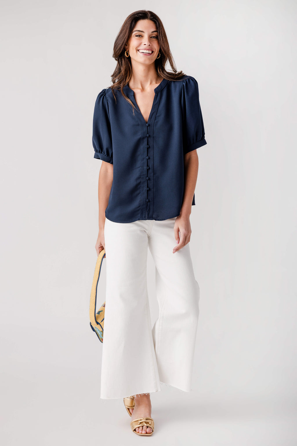 Navy puff-sleeve top with V-neck and button placket
