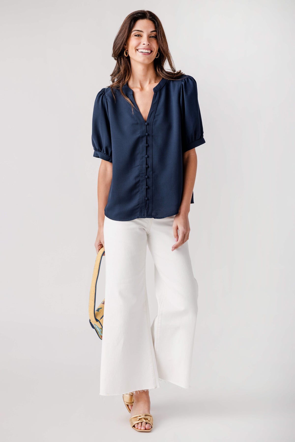 Navy puff-sleeve top with V-neck and button placket