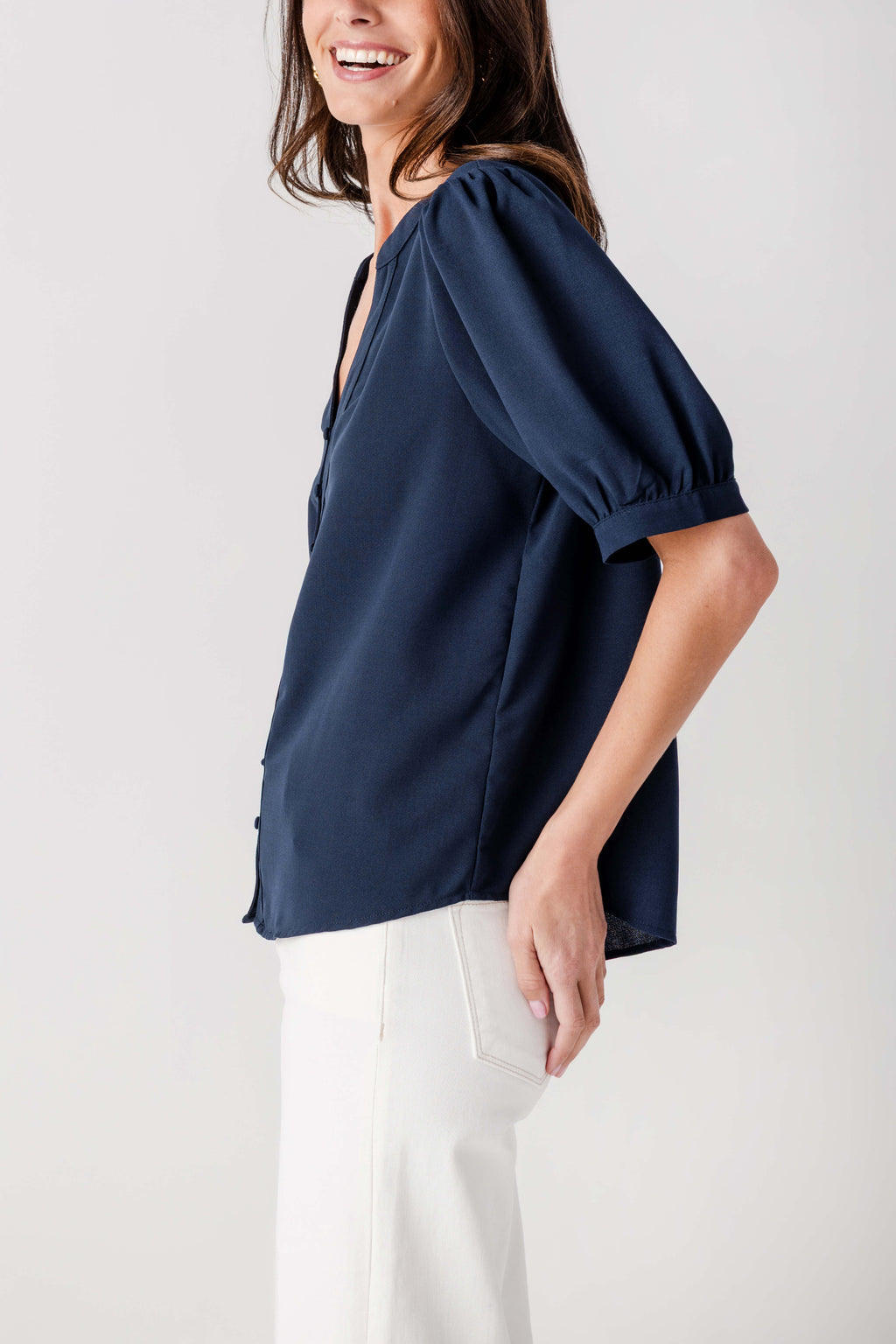 Navy puff-sleeve blouse top side view with button-front V-neck