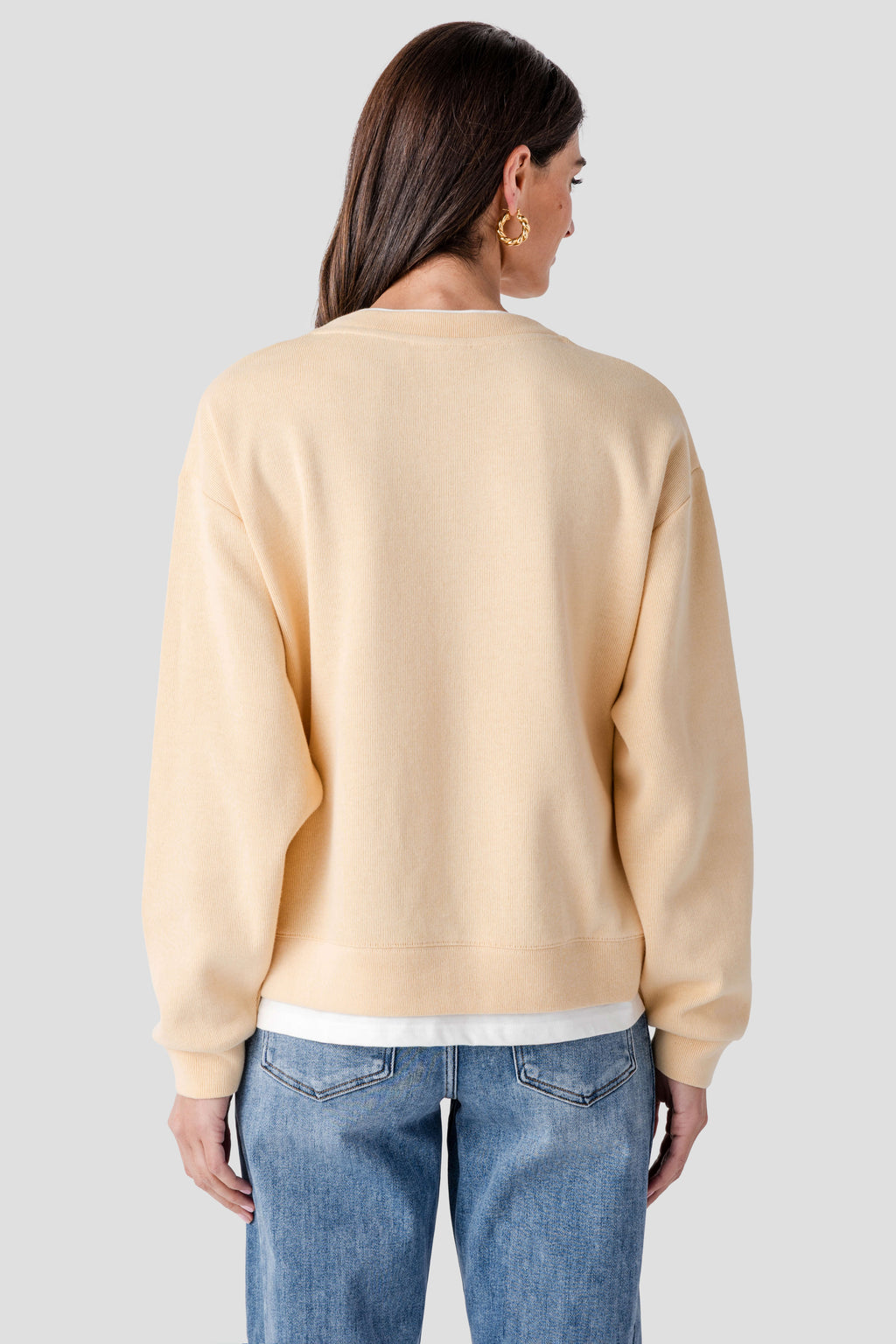 Light tan crewneck pullover, back view, long sleeves with ribbed cuffs and hem