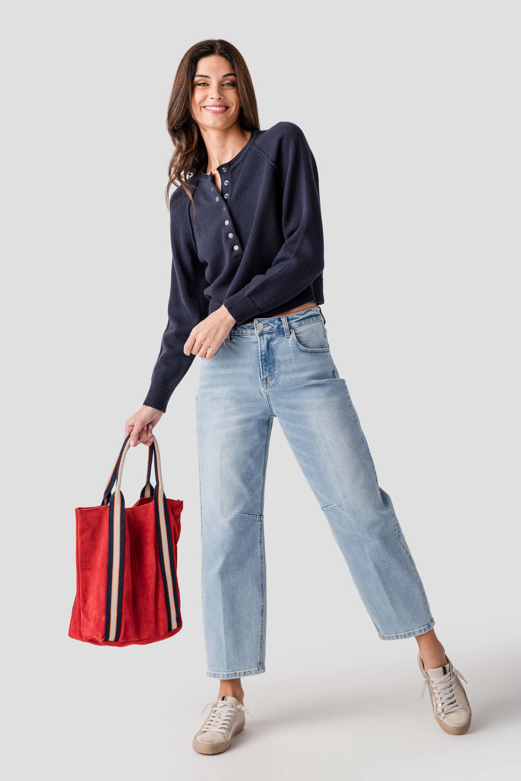 Women’s medium wash barrel jeans with straight barrel leg, ankle length, worn with sneakers.