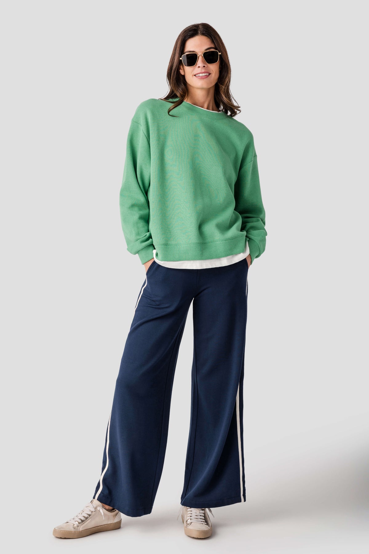 Green crewneck pullover with ribbed cuffs and hem, white trim at bottom edge