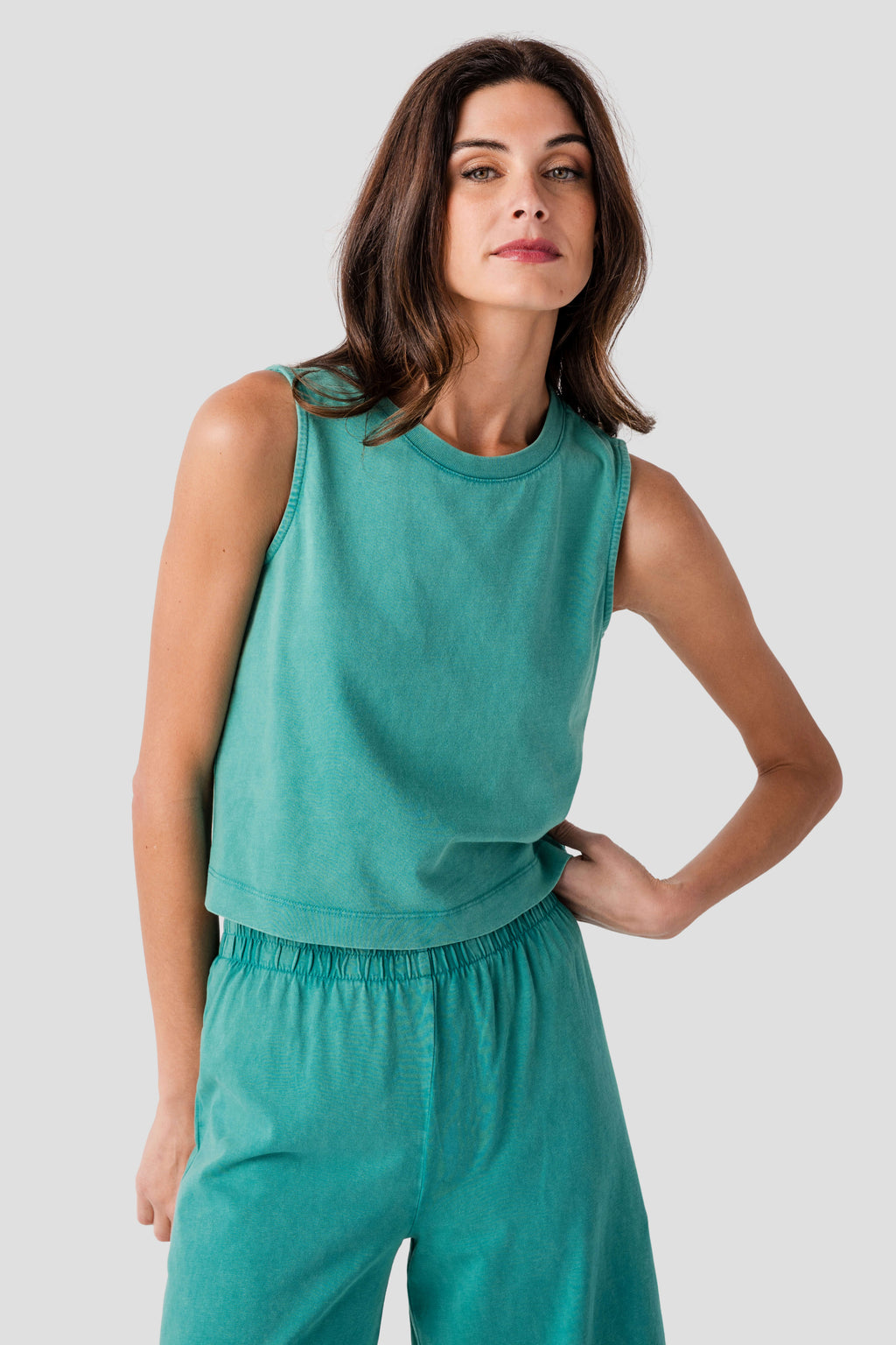 Teal sleeveless jersey muscle tank with crew neck and gathered waist panel.