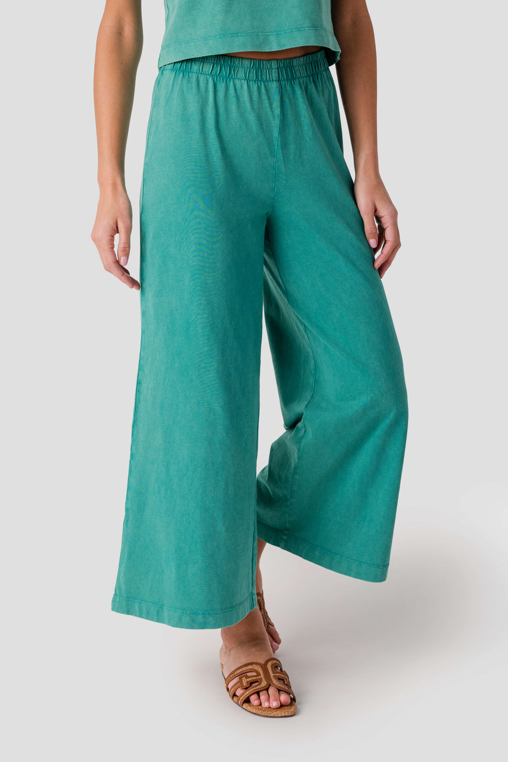 Teal jersey crop flare pants with elastic waistband and loose wide legs
