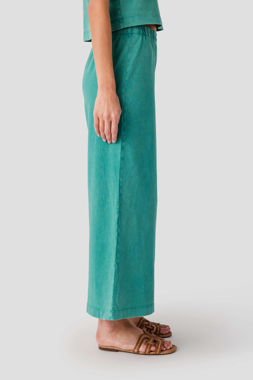 Teal jersey crop flare pants with elastic waistband and straight wide leg