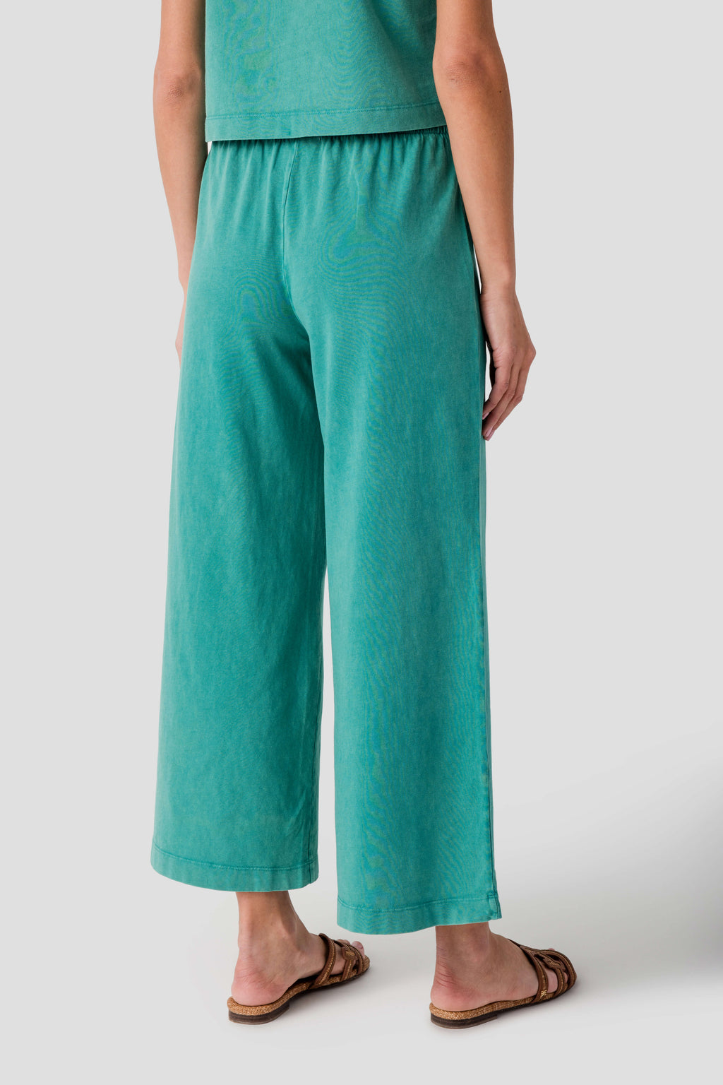 Teal jersey crop flare pants with elastic waistband and wide cropped legs