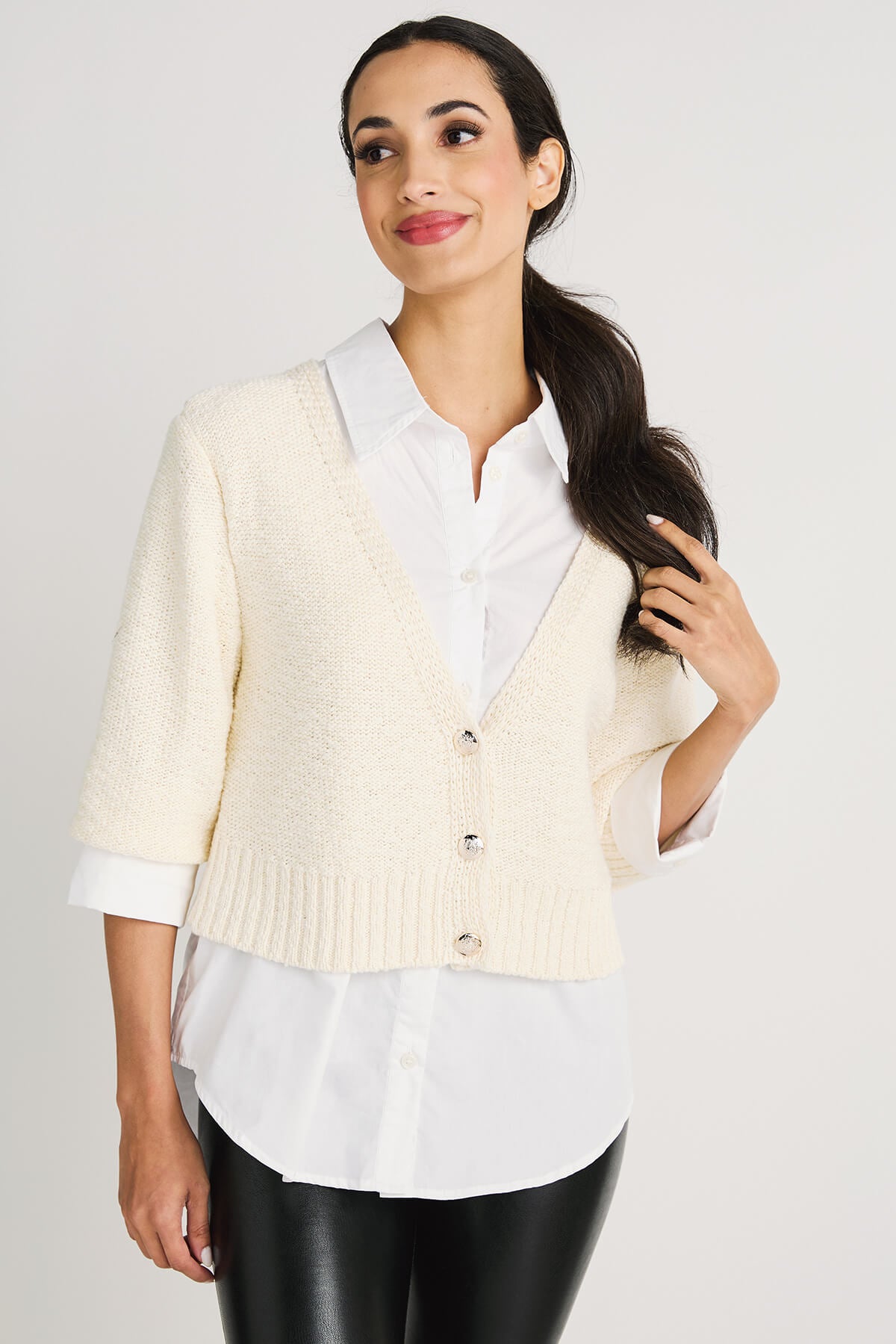 Off-white cropped knit cardigan sweater with V-neck, button front, and ribbed hem