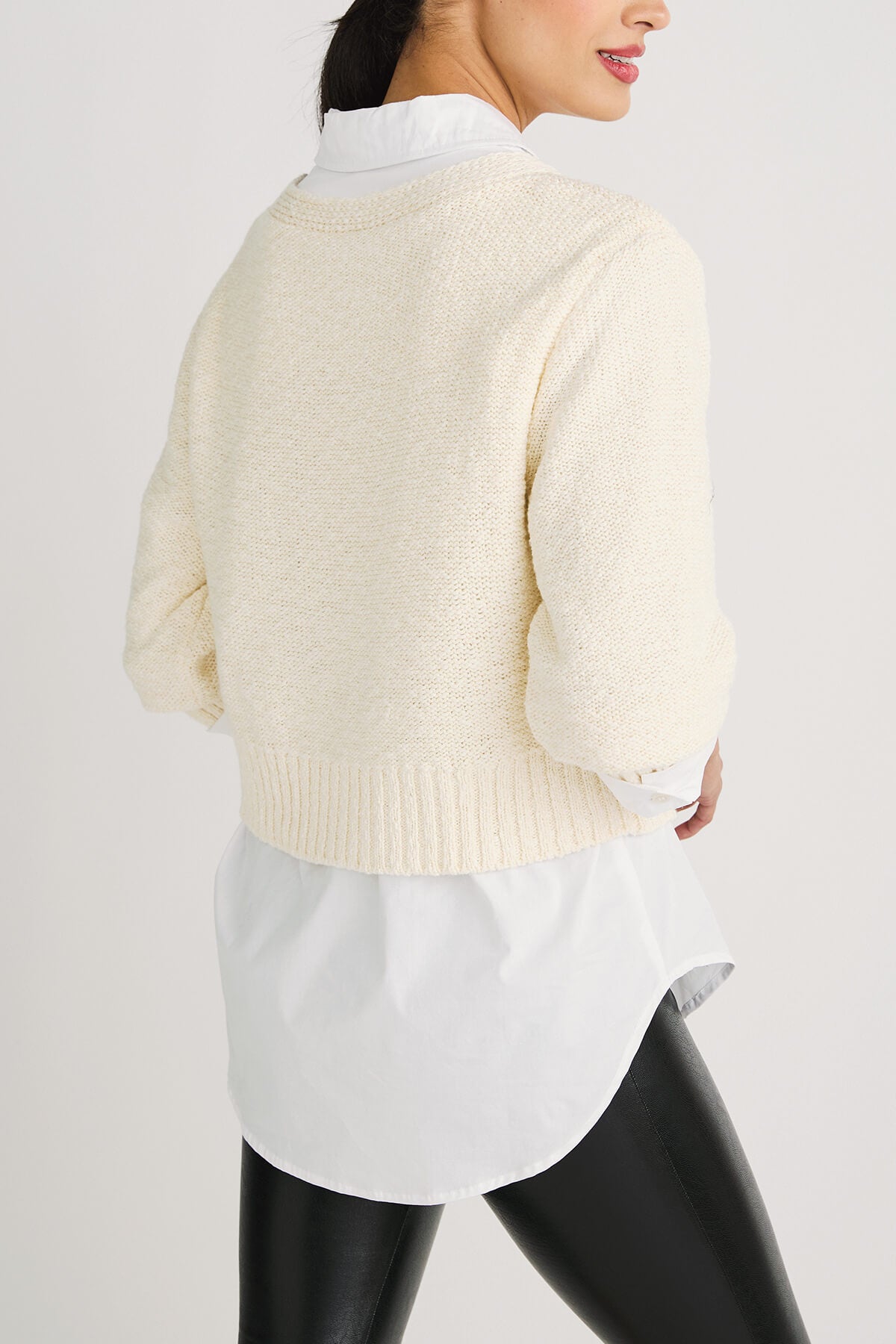 Off-white cropped cardigan sweater back view with ribbed waistband and knit texture