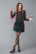 Hunter green velvet mini bubble skirt, angled view with ruffled hem and pleats